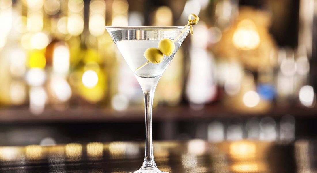 Mission 106 Luxury Apartments in Leawood, KS neighborhood with a closeup glass of martini dry cocktail with olives at bar counter