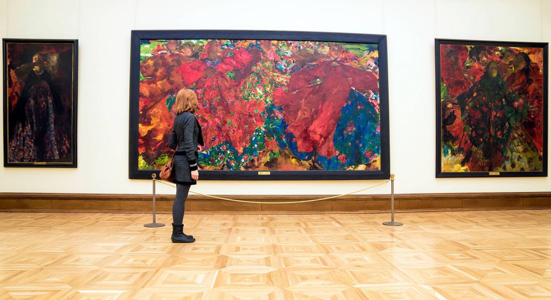 Mission 106 Luxury Apartments in Leawood, KS neighborhood with a woman at an art museum looking at a large artwork on the wall