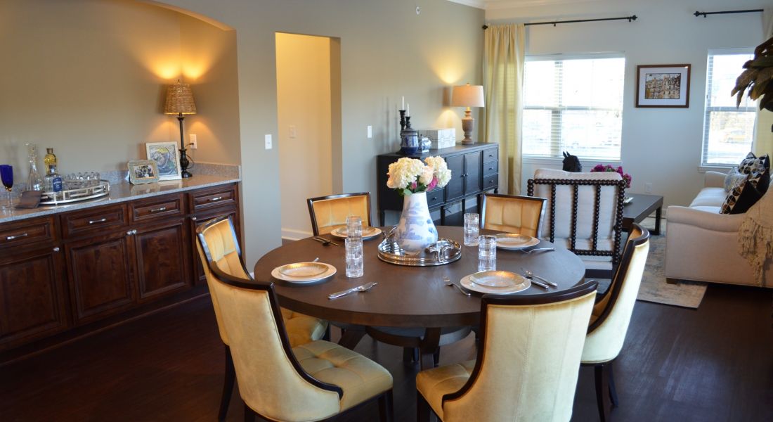 Mission 106 Luxury Apartments dining area with dining table, in-unit bar nook, and lots of natural light through the windows